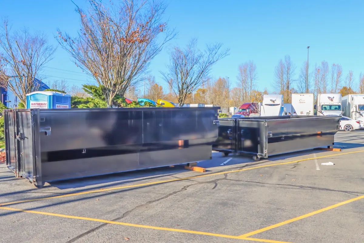 Professional dumpster rental service with roll-off container on residential driveway in Lennox